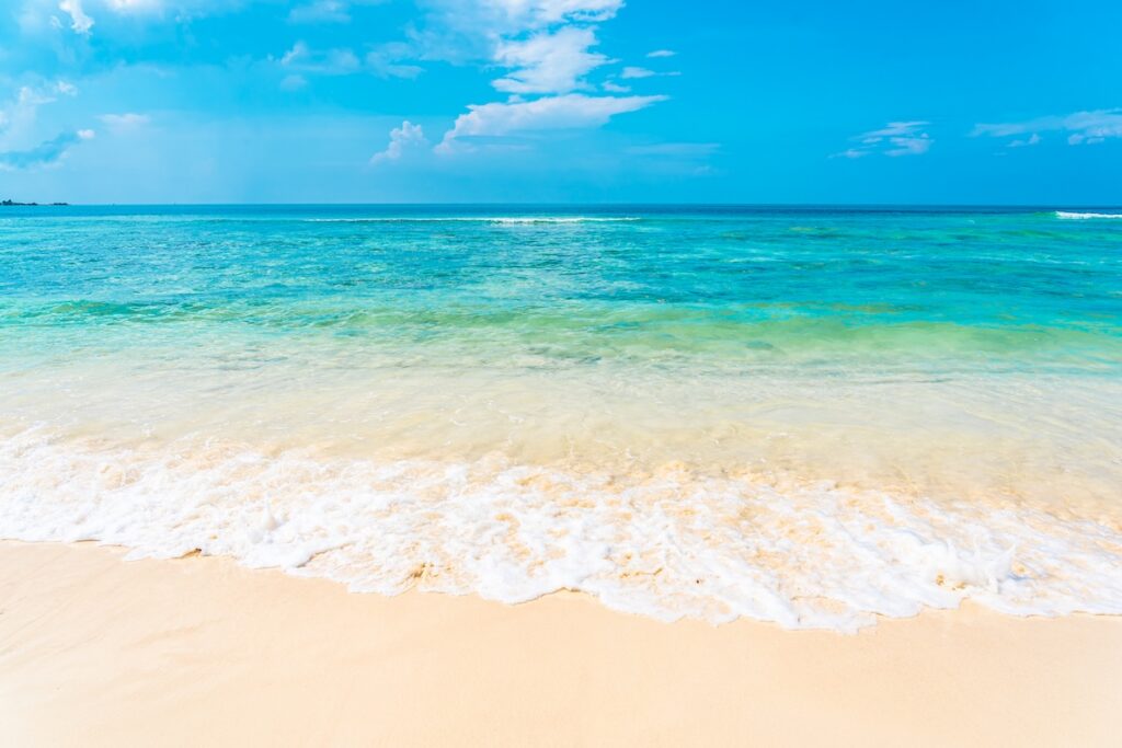 Empty tropical beach with clear water at a St. Thomas Charter Boats destination